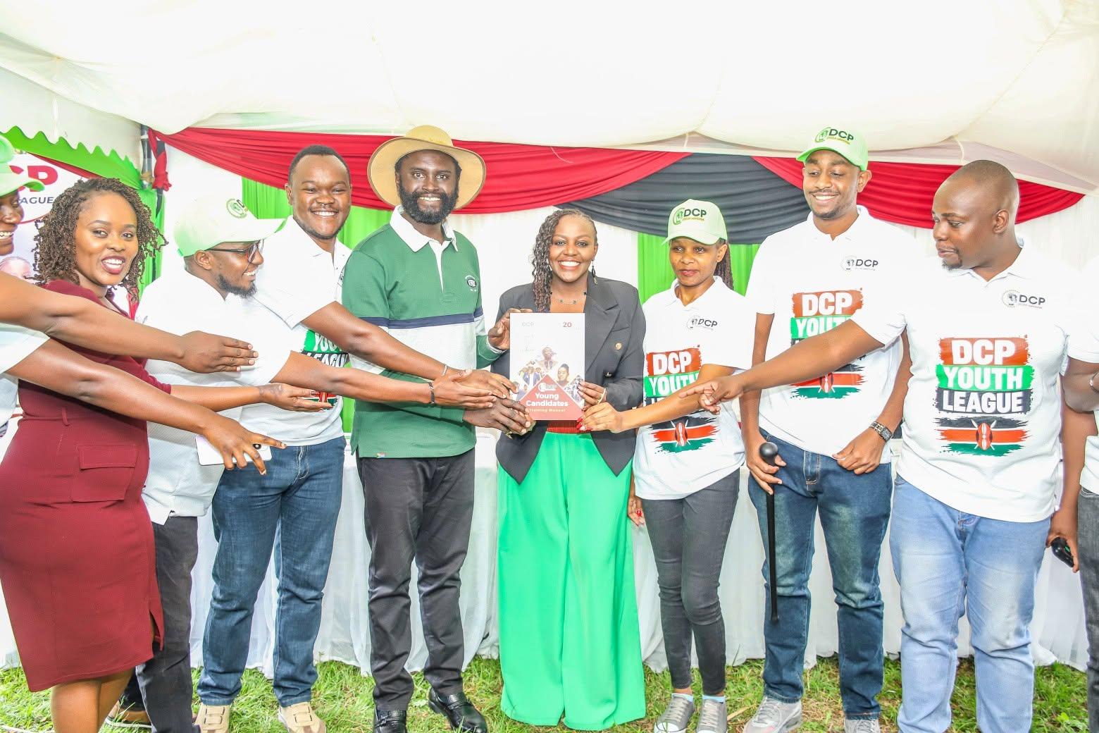 DCP Youth League members holding up the Young Candidates training manual at its launch